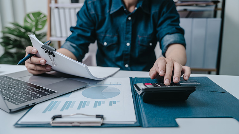 Insurance documents with calculator and California state flag in the background